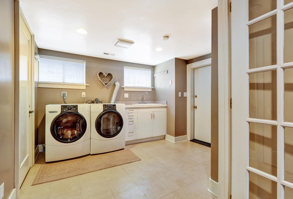 A warmly decorated laundry room with floor tiles from Delray