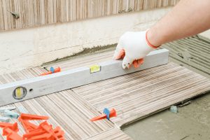 A tiler's hand with level.